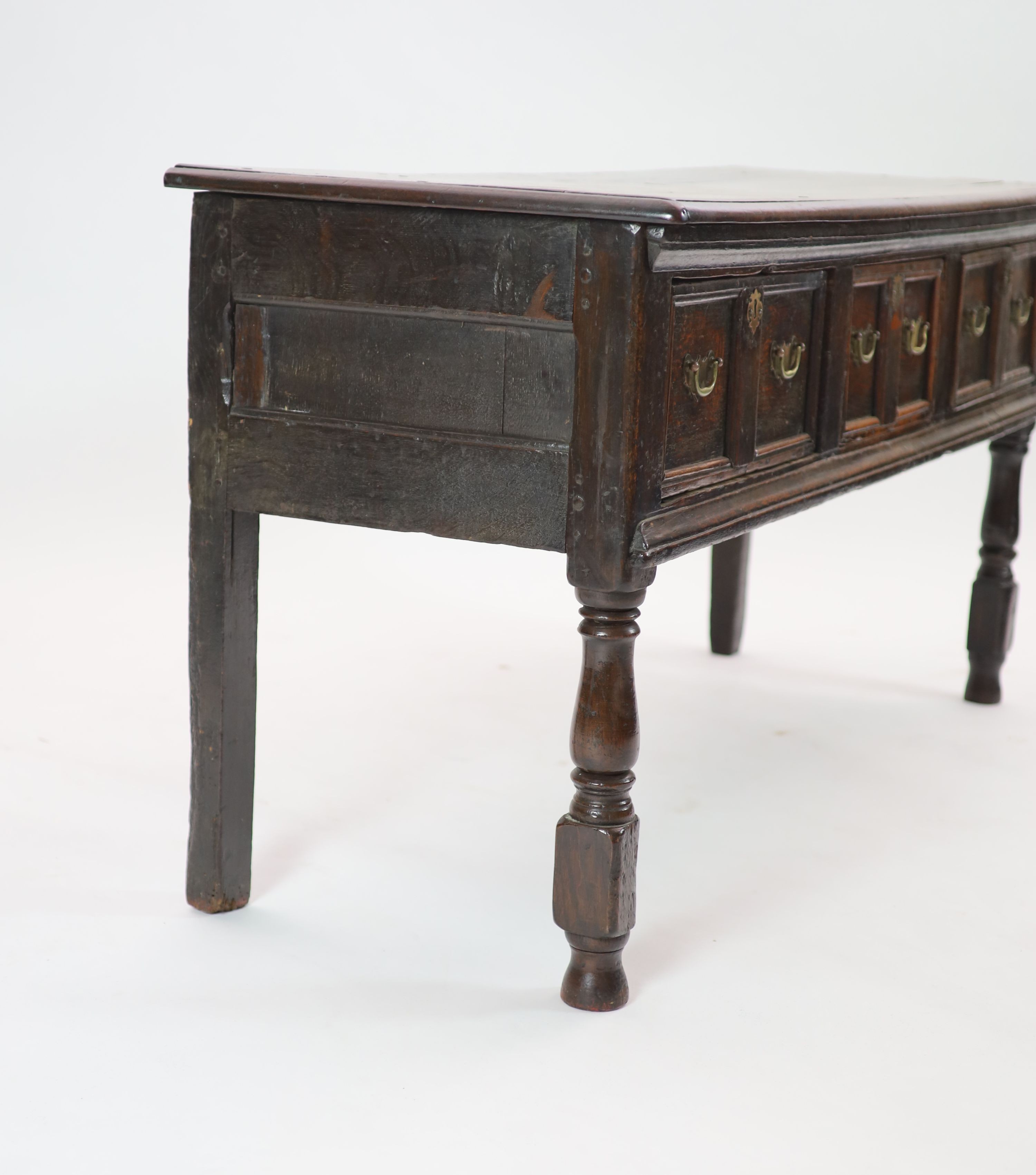 A late 17th century oak low dresser H 76cm. W 154cm. D 54cm.